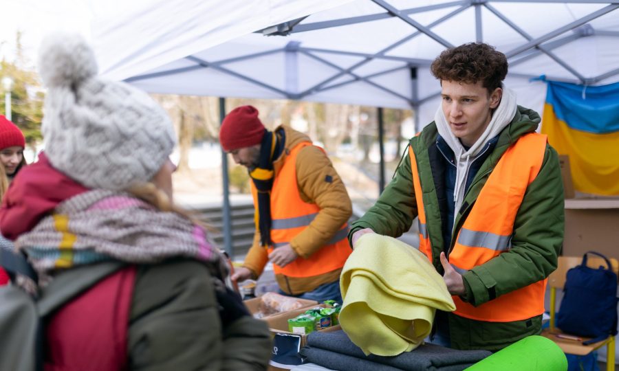 Volunteers distributing blankets and other donations to refugees on the Ukrainian border. The volunteers distributing blankets and other donations to refugees on the Ukrainian border.